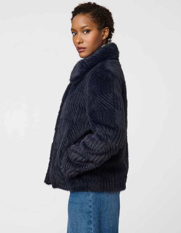 Soft faux fur jacket with square-pattern texture, snap buttons, and stand collar for cold-weather elegance.