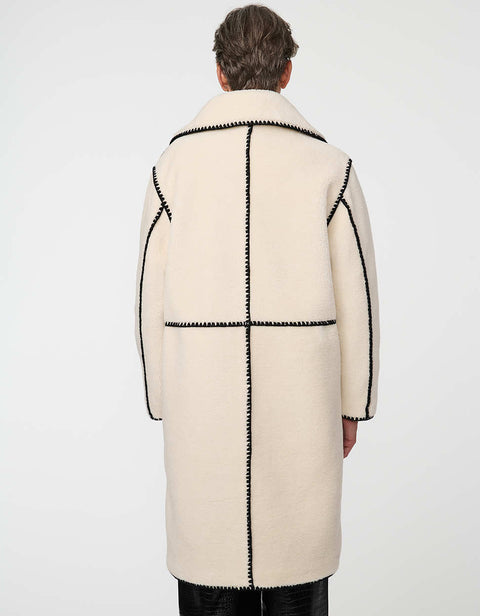 Calf-length faux fur coat with scalloped stitching, oversized lapels, and patch pockets for cozy sophistication.