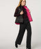 Women's black and pink reversible puffer vest for breast cancer awareness month. Lightweight for effortless layering.