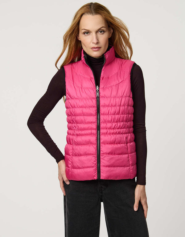 Women's black and pink reversible puffer vest for breast cancer awareness month. Lightweight for effortless layering.