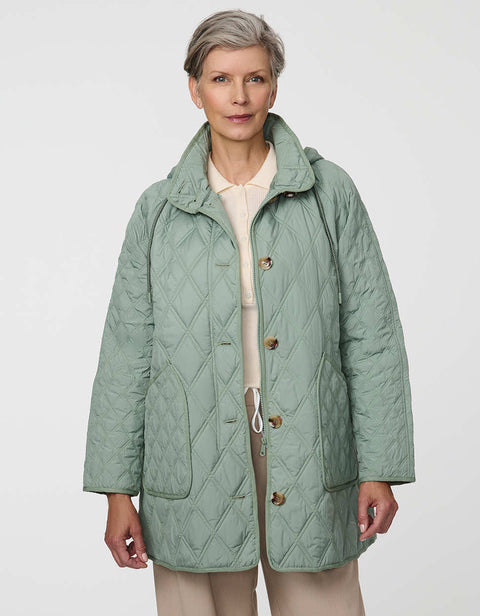 Lightweight quilted puffer jacket for women. The perfect spring layer with drawstring hood and oversized pockets,