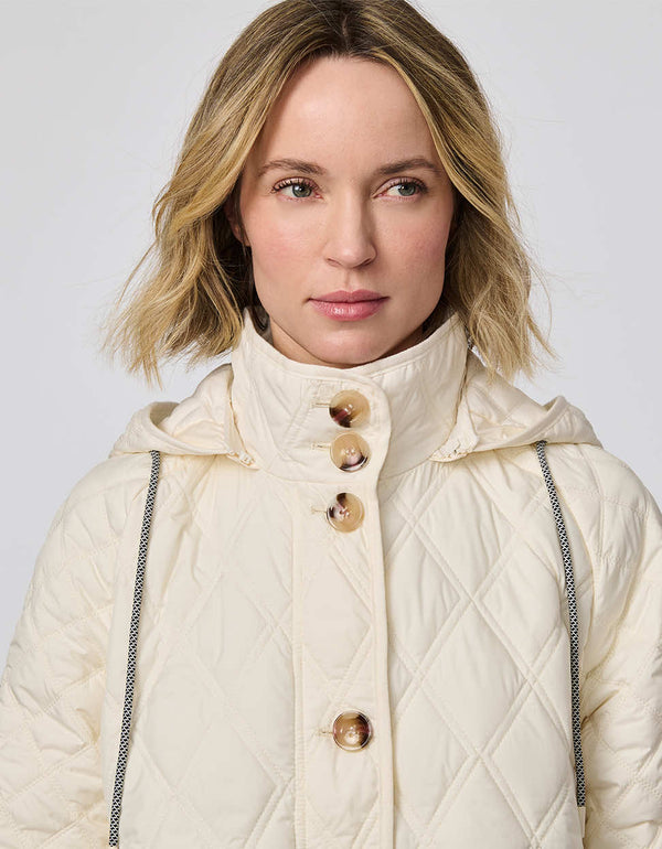 Lightweight quilted puffer jacket for women. The perfect spring layer with drawstring hood and oversized pockets,