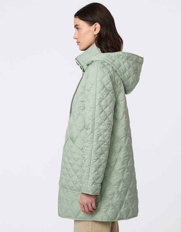 Lightweight quilted puffer jacket for women. The perfect spring layer with drawstring hood and oversized pockets,