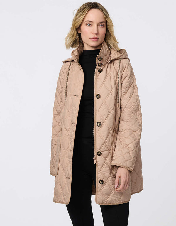 Lightweight quilted puffer jacket for women. The perfect spring layer with drawstring hood and oversized pockets,