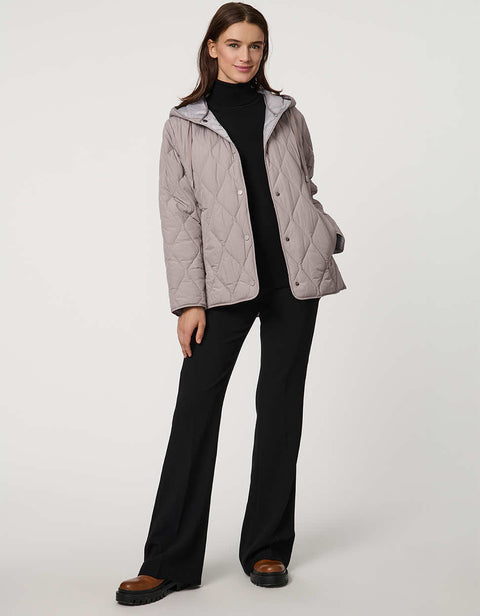 Oversized quilted puffer jacket with diamond stitching, drawstring hood, welt pockets, and snap front closures.
