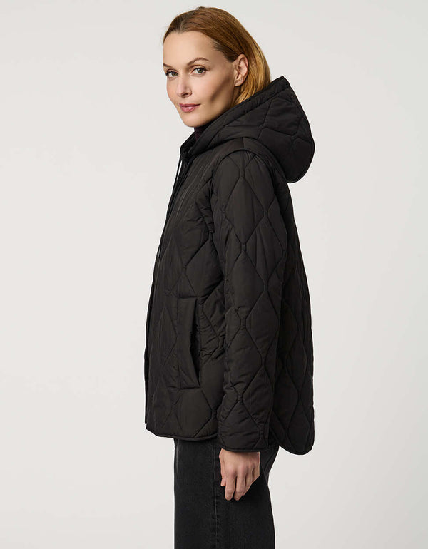 Oversized quilted puffer jacket with diamond stitching, drawstring hood, welt pockets, and snap front closures.