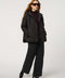 Oversized quilted puffer jacket with diamond stitching, drawstring hood, welt pockets, and snap front closures.