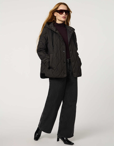 Oversized quilted puffer jacket with diamond stitching, drawstring hood, welt pockets, and snap front closures.