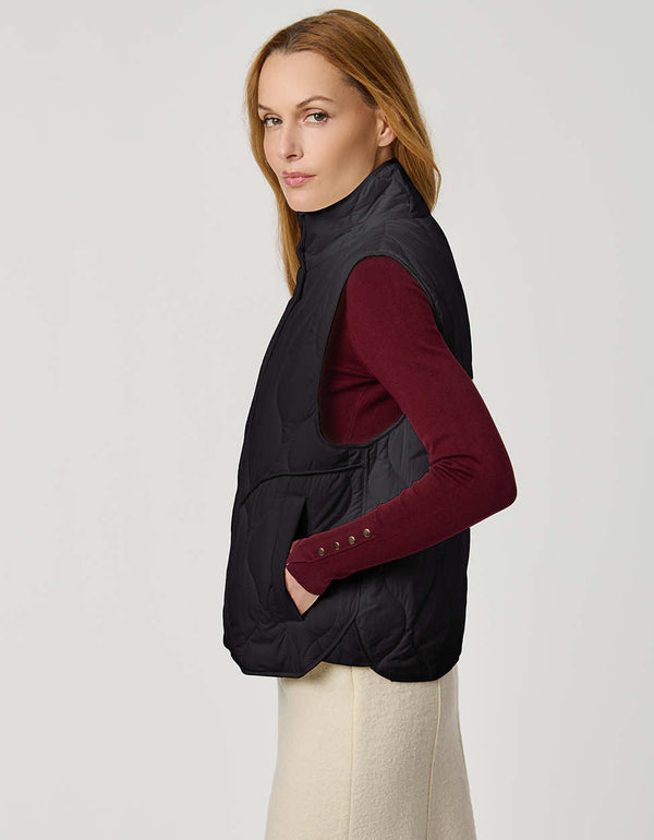 Women’s quilted puffer vest with oversized fit, funnel collar, zipper closure, and lightweight Ecoplume fill.