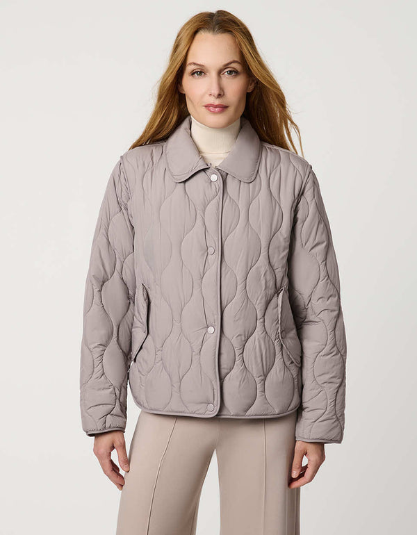 Classic quilted women’s puffer jacket with structured collar, snap closures, patch pockets, and Ecoplume fill.