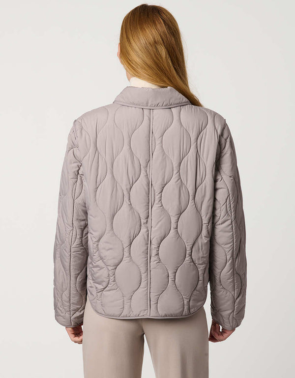 Classic quilted women’s puffer jacket with structured collar, snap closures, patch pockets, and Ecoplume fill.