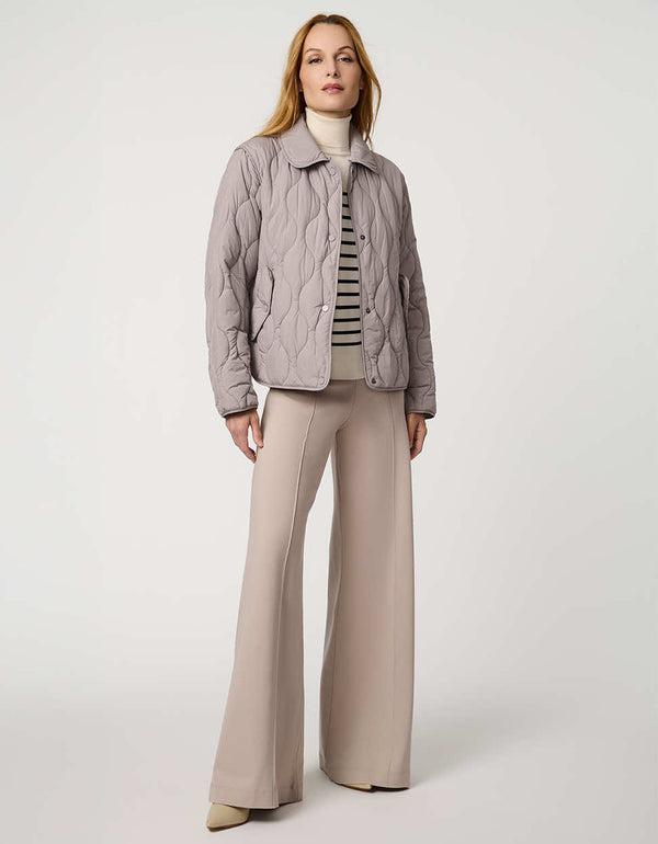 Classic quilted women’s puffer jacket with structured collar, snap closures, patch pockets, and Ecoplume fill.