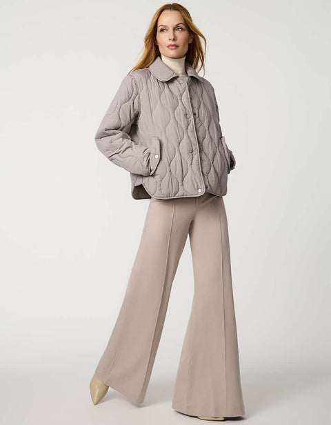 Classic quilted women’s puffer jacket with structured collar, snap closures, patch pockets, and Ecoplume fill.