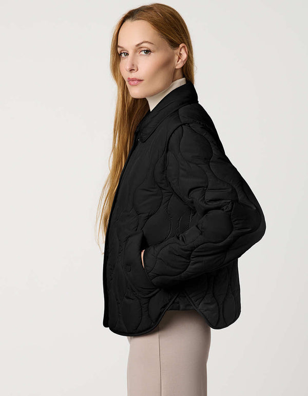 Classic quilted women’s puffer jacket with structured collar, snap closures, patch pockets, and Ecoplume fill.