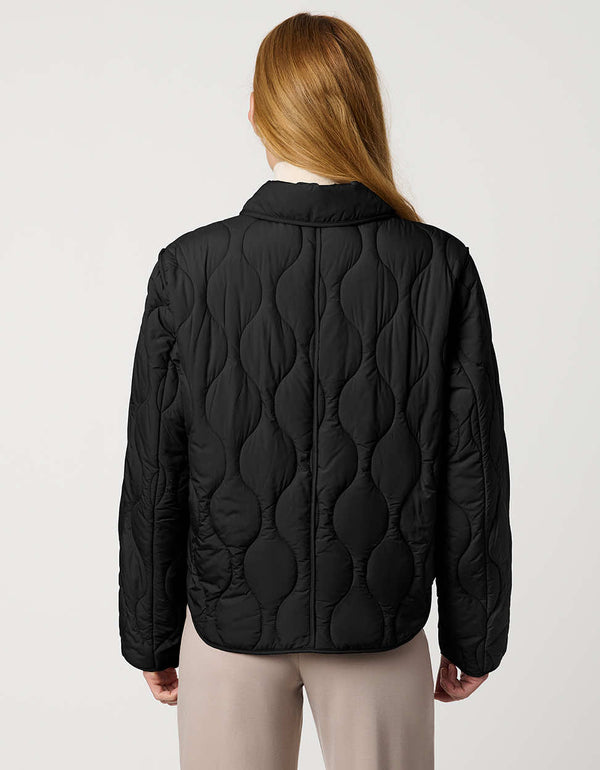 Classic quilted women’s puffer jacket with structured collar, snap closures, patch pockets, and Ecoplume fill.