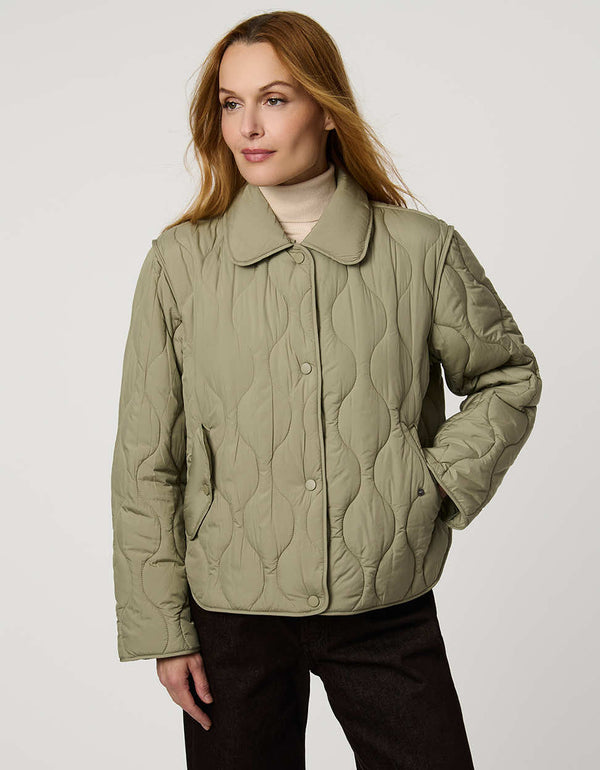 Classic quilted women’s puffer jacket with structured collar, snap closures, patch pockets, and Ecoplume fill.