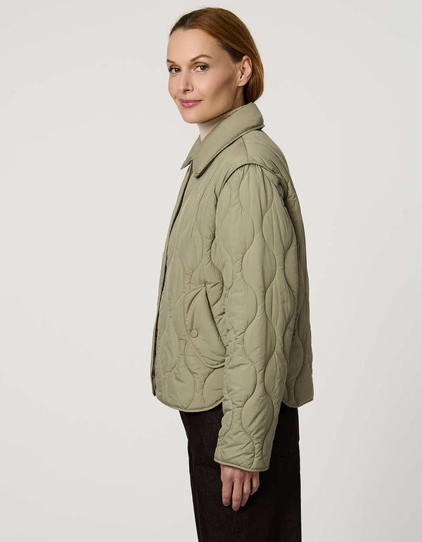Classic quilted women’s puffer jacket with structured collar, snap closures, patch pockets, and Ecoplume fill.