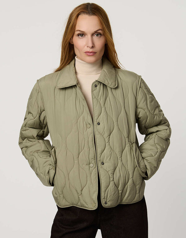 Classic quilted women’s puffer jacket with structured collar, snap closures, patch pockets, and Ecoplume fill.