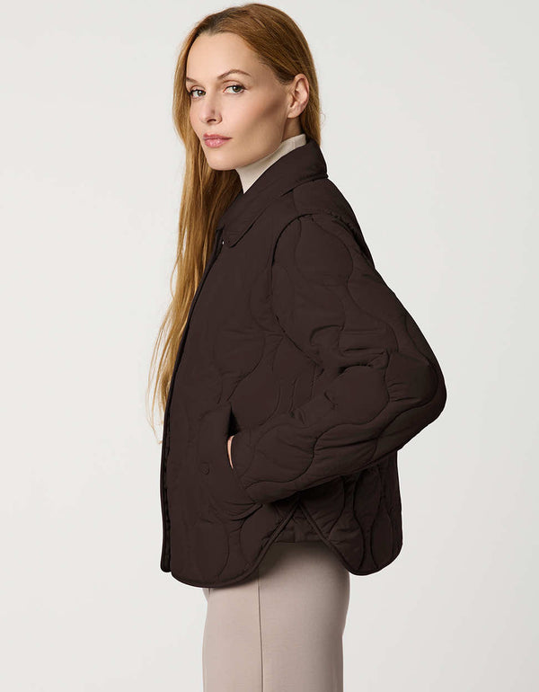 Classic quilted women’s puffer jacket with structured collar, snap closures, patch pockets, and Ecoplume fill.