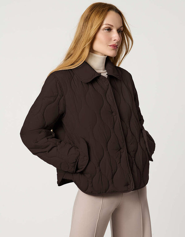 Classic quilted women’s puffer jacket with structured collar, snap closures, patch pockets, and Ecoplume fill.