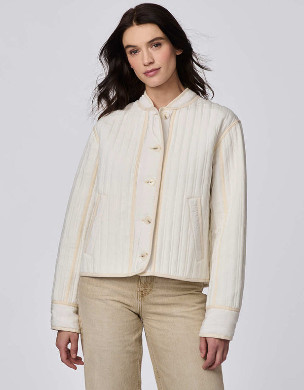 Cropped quilted jacket with boxy silhouette, structured collar, statement buttons, and practical pockets. A flattering, lightweight jacket for transitional seasons.