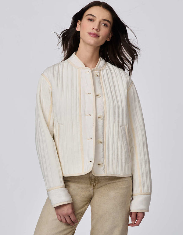 Cropped quilted jacket with boxy silhouette, structured collar, statement buttons, and practical pockets. A flattering, lightweight jacket for transitional seasons.