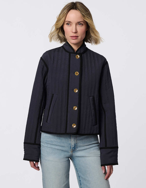 Cropped quilted jacket with boxy silhouette, structured collar, statement buttons, and practical pockets. A flattering, lightweight jacket for transitional seasons.