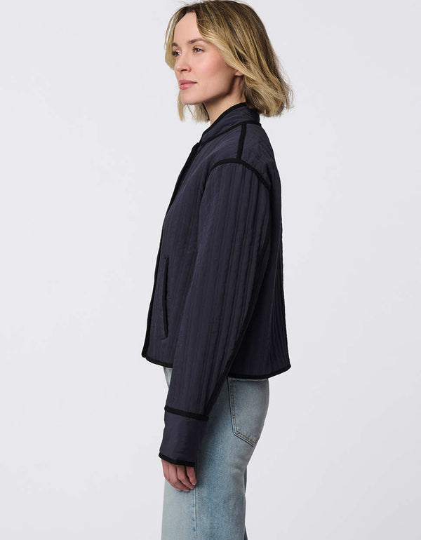 Cropped quilted jacket with boxy silhouette, structured collar, statement buttons, and practical pockets. A flattering, lightweight jacket for transitional seasons.