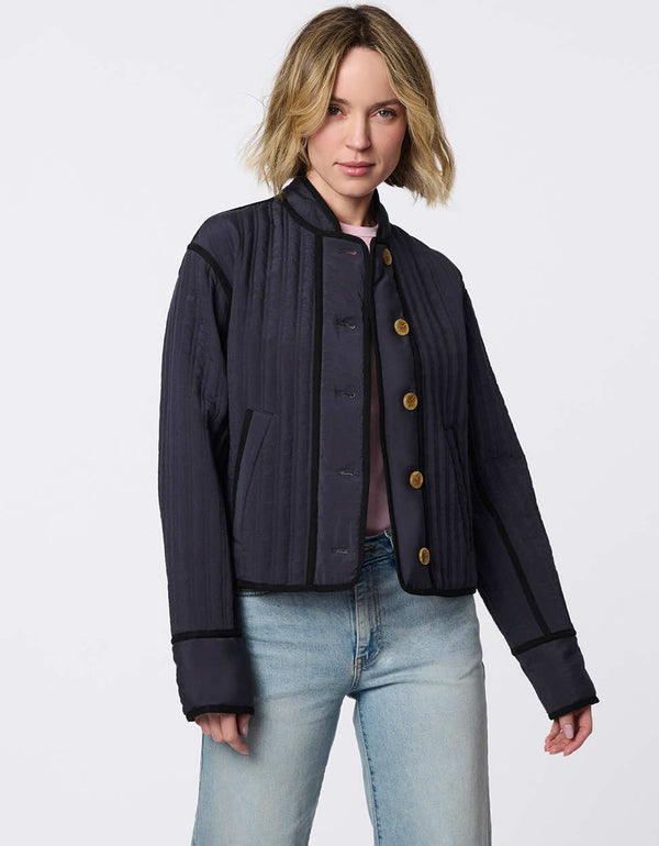 Cropped quilted jacket with boxy silhouette, structured collar, statement buttons, and practical pockets. A flattering, lightweight jacket for transitional seasons.