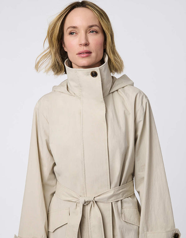 Oversized trench coat with fold-away hood, funnel collar, flared sleeves, and zip closure. Versatile and chic, perfect for city streets and weekend getaways.