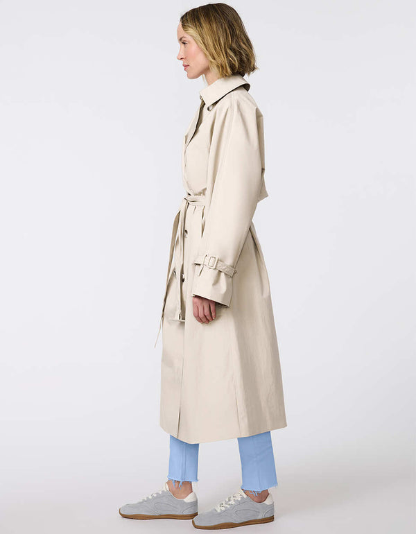 Women's classic beige trench coat. Lightweight, design with a self-tie belt, double-breasted closure. Perfect for layering in transitional weather.