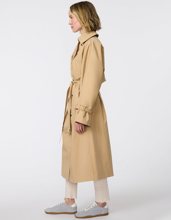 Women's classic beige trench coat. Lightweight, design with a self-tie belt, double-breasted closure. Perfect for layering in transitional weather.