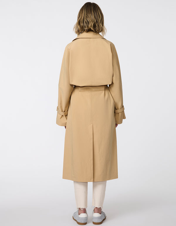 Women's classic beige trench coat. Lightweight, design with a self-tie belt, double-breasted closure. Perfect for layering in transitional weather.