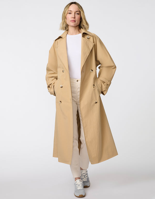 Women's classic beige trench coat. Lightweight, design with a self-tie belt, double-breasted closure. Perfect for layering in transitional weather.