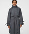 Calf-length women’s trench coat with belt, adjustable cuffs, and packable hood, ideal for transitional weather.