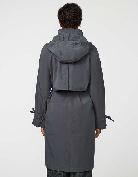 Calf-length women’s trench coat with belt, adjustable cuffs, and packable hood, ideal for transitional weather.