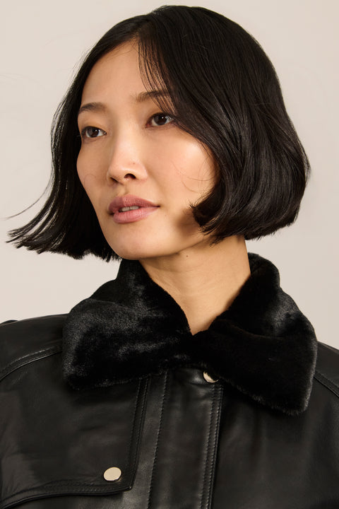 women's black genuine leather belted jacket with a removable black faux fur collar, snap-front closure and utility pockets.