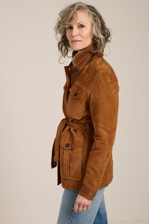 Genuine suede safari jacket with leather trim, self-tie belt, oversized flap pockets and concealed button-front closure.