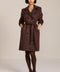 women's faux suede trench coat with a double-breasted front, notched lapels, belted waist and buckle cuff details.