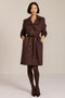 women's faux suede trench coat with a double-breasted front, notched lapels, belted waist and buckle cuff details.