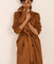women's faux suede trench coat with a double-breasted front, notched lapels, belted waist and buckle cuff details.