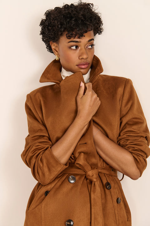 women's faux suede trench coat with a double-breasted front, notched lapels, belted waist and buckle cuff details.