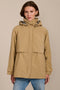 Women's hooded raincoat with drawstring waist, storm flap, side pockets and adjustable cuffs.
