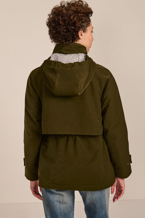 Women's hooded raincoat with drawstring waist, storm flap, side pockets and adjustable cuffs.
