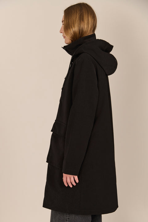 Women's black All-Weather Parka with an oversized hood, utility pockets and longline silhouette.