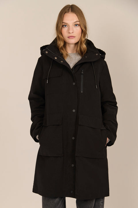 Women's black All-Weather Parka with an oversized hood, utility pockets and longline silhouette.