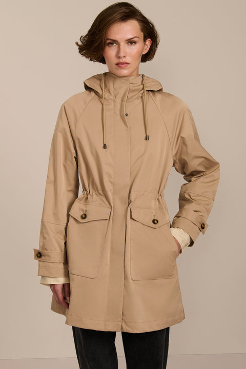 Women's raincoat with drawstring waist and hood.