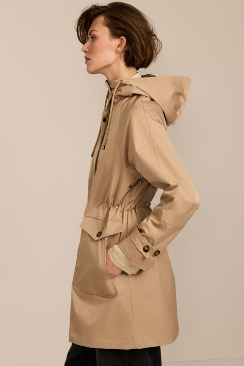 Women's raincoat with drawstring waist and hood.