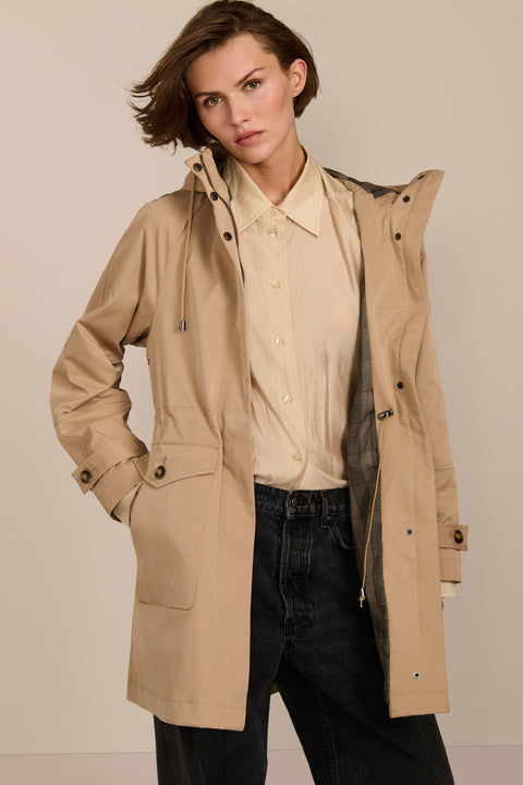 Women's raincoat with drawstring waist and hood.