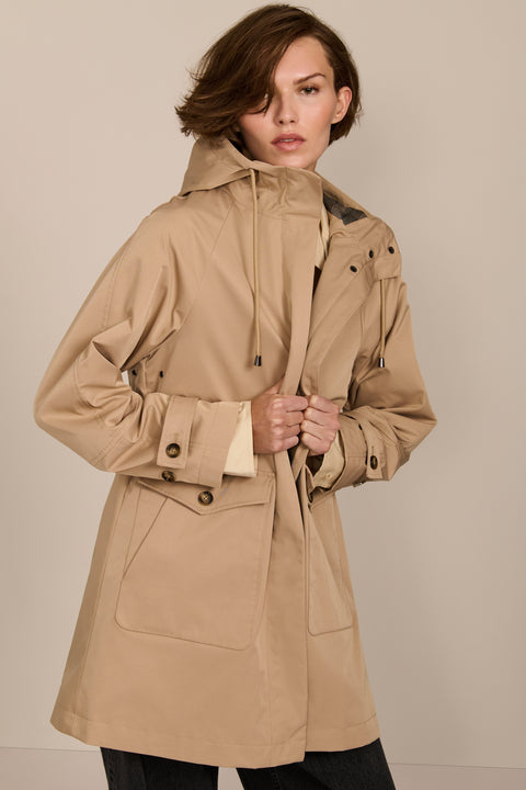 Women's raincoat with drawstring waist and hood.